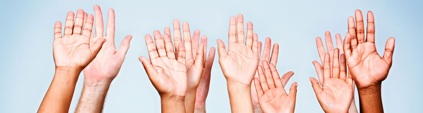 Hands from employee resource group individuals raised, volunteering to make a difference
