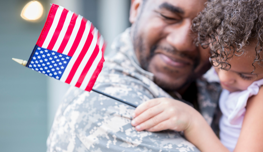 United States soldier happily embracing his daughter