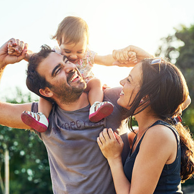 Happy family outside their home